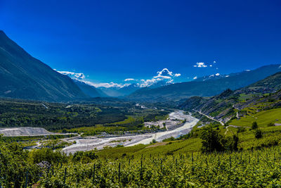 Scenic view of mountains against clear blue sky