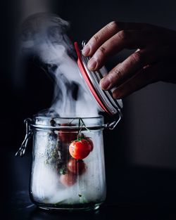 Close-up of hand with ice cream in glass