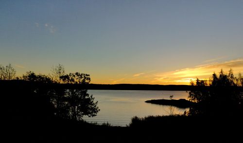 Scenic view of lake against sky during sunset