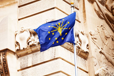 Low angle view of flag against building