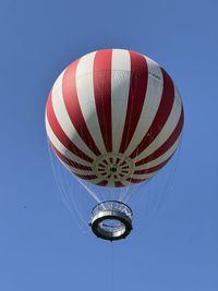 Low angle view of american flag against clear blue sky