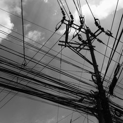 Low angle view of power lines against sky