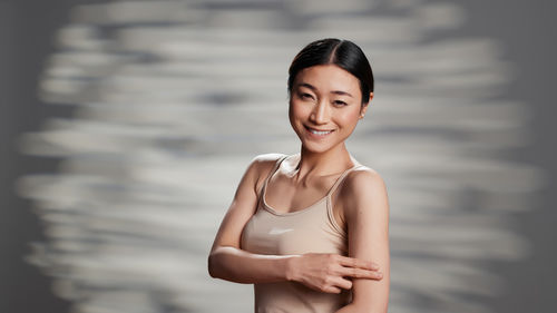 Portrait of young woman standing outdoors