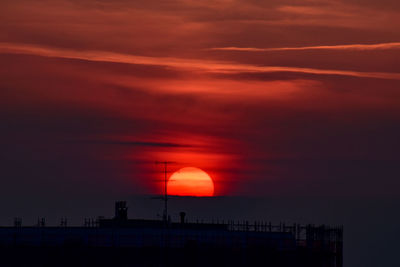 Silhouette building against sky during sunset