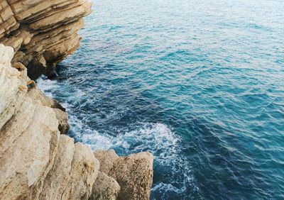 High angle view of rock formation by sea