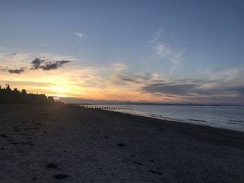 Scenic view of beach against sky during sunset