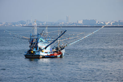 Sailboat sailing in sea against clear sky