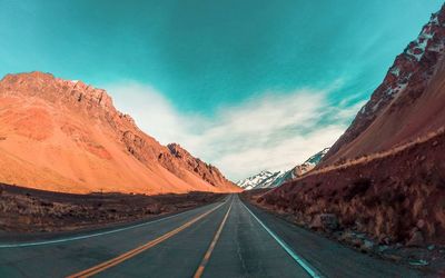 Road amidst mountains against sky