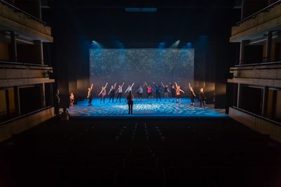 People in illuminated room