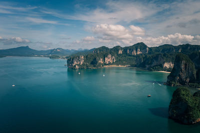 Scenic view of sea and mountains against sky