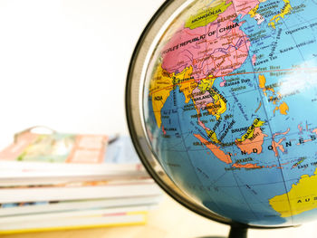 Countries and continents with colorful map on globe with books in the background. education concept.