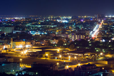 Aerial view of city lit up at night