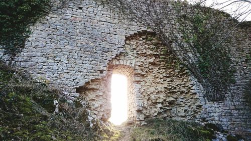 Low angle view of stone wall in sunlight