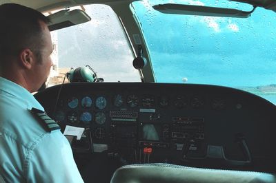 View of man and airplane against sky