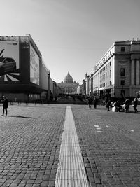 People on street in city against clear sky