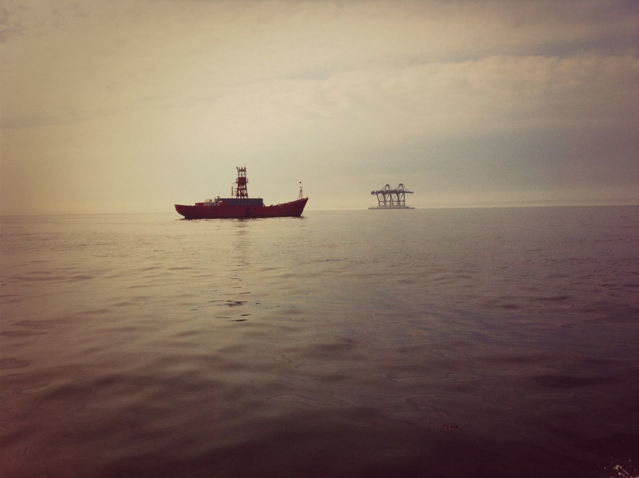 sea, water, nautical vessel, transportation, waterfront, horizon over water, mode of transport, boat, sky, tranquility, tranquil scene, scenics, beauty in nature, rippled, nature, sailing, sunset, cloud - sky, idyllic, seascape