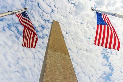 Low angle view of flag flags against sky