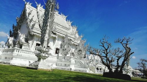 Low angle view of statue against blue sky