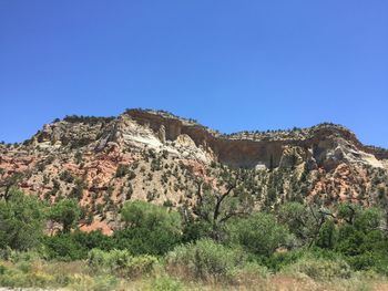 Scenic view of rocky mountains against clear blue sky