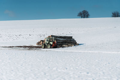 Lifeguard hut on snowy field against clear sky during winter