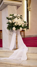 Flower vase against white wall