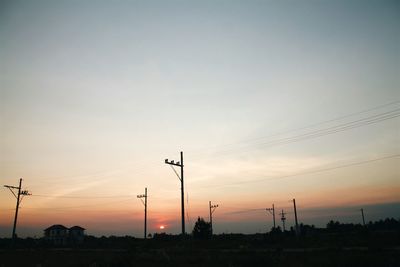 Low angle view of electricity pylon against sky