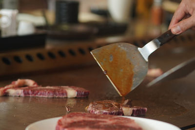 Close-up of person preparing food on table