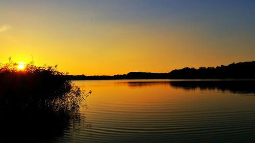 Scenic view of lake at sunset