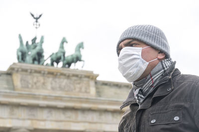 Low angle view of man standing against building