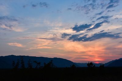 Scenic view of silhouette mountains against sky during sunset