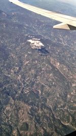 Aerial view of airplane wing over landscape