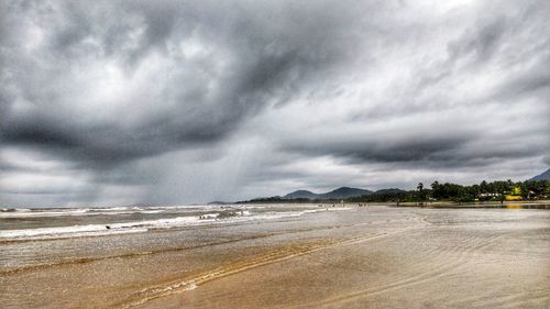 Scenic view of sea against storm clouds