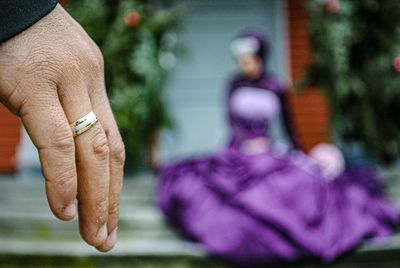 Cropped hand of man against woman