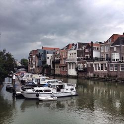 Boats in canal with buildings in background