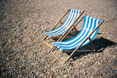 Blue deck chairs at beach