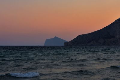 Scenic view of sea against orange sky