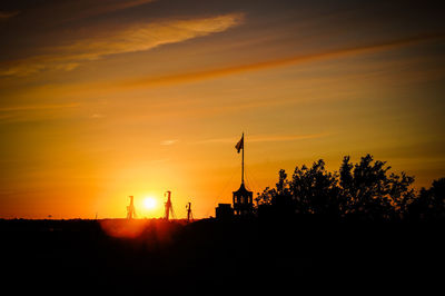 Silhouette trees against sky during sunset