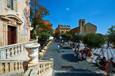 People on steps in city