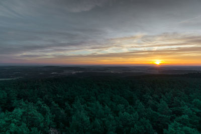 Scenic view of field against sky during sunset