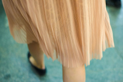 Low section of woman wearing shirt while walking outdoors