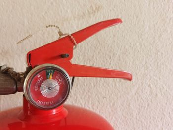 Close-up of red toy car against wall