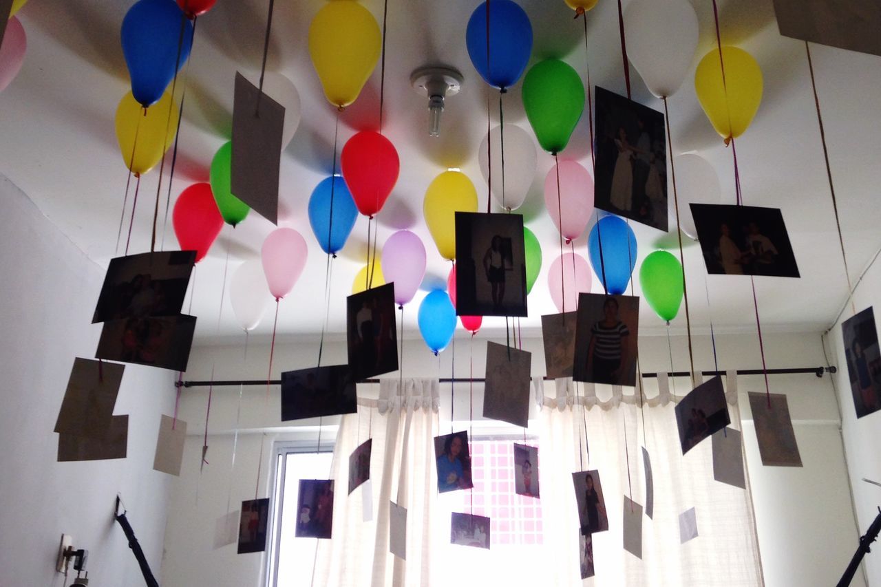 multi colored, colorful, low angle view, hanging, balloon, variation, decoration, in a row, blue, large group of objects, celebration, no people, architecture, built structure, flag, pattern, arrangement, side by side, abundance, indoors