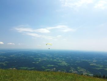 Scenic view of landscape against sky, paragliders