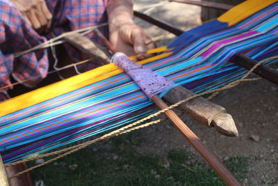 Cropped hands weaving loom