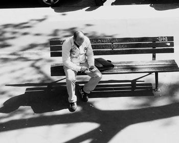 Full length of woman sitting outdoors