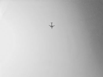 Low angle view of airplane against clear sky