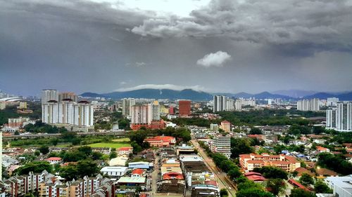 Residential buildings against cloudy sky