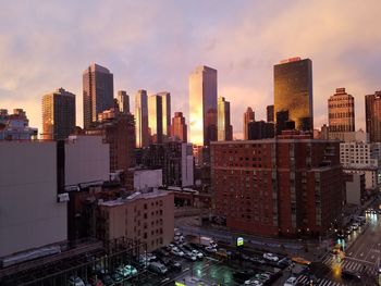 View of skyscrapers against cloudy sky