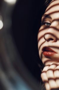 Close-up of young woman reflecting on mirror