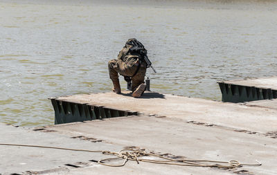 Deck chairs on railing by lake